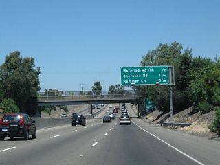 This mileage sign along California 99 north provides the distance to the next three exits: Exit 255, California 88 (Waterloo Road) east and Waterloo Road west; Exit 256, Cherokee Road; and Exit 258, San Joaquin County Route J-8 (Hammer Lane). Exit 257 (a frontage road off-ramp) no longer exists.