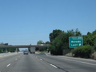Northbound California 99 meets Exit 259, Morada Lane. Morada Lane leads west into Morada, then connects to San Joaquin County Route J-3 (West Lane).