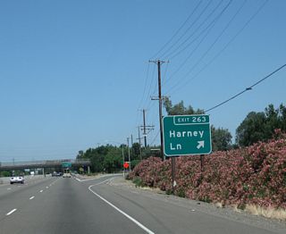 Northbound California 99 meets Exit 263, Harney Lane.