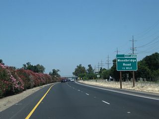 The next exit along California 99 north is Exit 268, Woodbridge Road (one-half mile). This was one of the first exit number signs to come to this stretch of California 99, as it was installed prior to August 2003.