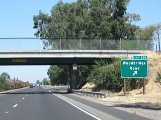 Northbound California 99 meets Exit 268, Woodbridge Road.