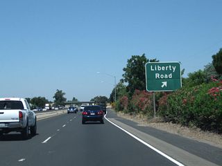 Northbound California 99 reaches Exit 273, Liberty Road. This is the last exit in San Joaquin County; after crossing the Dry Creek, California 99 will enter Sacramento County and the city of Galt.