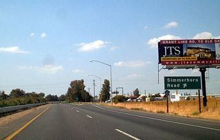 The next exit along California 99 north is Exit 275A, Simmerhorn Road to Sacramento County J-10 (Lincoln Way) south. This exit marks the northern terminus of CR J-10, which leads south into San Joaquin County to follow Sacramento Road south through Woodbridge, past Lodi, en route to Stockton.