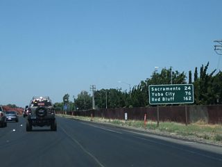 This mileage sign along California 99 north provides the distance to Sacramento (24 miles), Yuba City (76 miles), and Red Bluff (162 miles).