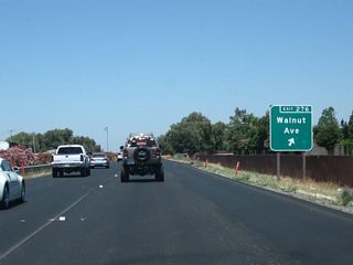 Northbound California 99 meets Exit 276, Walnut Avenue. After this exit, California 99 proceeds north to cross Deadman Gulch and will continue toward the next northbound interchange: Exit 277, California 104 east and Sacramento County Route E-13 west via Twin Cities Road.