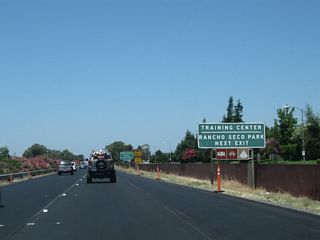 Use California 104 (Twin Cities Road) east to Rancho Seco, site of a former nuclear power generating station owned and operated by the Sacramento Municipal Utility District (SMUD). Rancho Seco began commercial operation on April 18, 1975, and it shut down operations with final defueling of the facility on December 8, 1989. The two cooling towers, which are of a design common to many nuclear power generating facilities, are visible from quite a distance from the site, with access to the natural gas-fired Consumnes Power Plant that opened in 2006. Today the site is mostly a preserve (Rancho Seco Lake and Howard Ranch), with intersecting power lines linking near the site to connect the former plant to the power grid. Much of the land at the plant was cleared for public use in 2009.