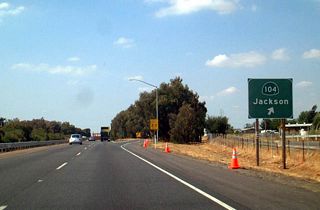 Northbound California 99 meets Exit 277, California 104 east to Ione and Jackson and Sacramento County Route E-13 west to Walnut Grove (with connections to California 160 and California 220).