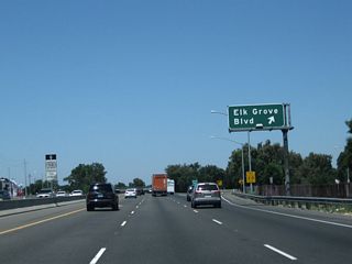 Northbound California 99 meets Exit 286, Sacramento County Route E-12 (Elk Grove Boulevard). Sacramento County Route E-12 starts at its junction with Interstate 5 just west of here, and it connects with Sacramento County Route E-2 (Grant Line Road) east of Elk Grove. Regional travelers may notice that a separate segment of Grant Line Road several miles southwest of here has an exit along Interstate 205.