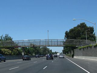 Leaving Fruitridge Road behind, a pedestrian bridge passes over California 99.