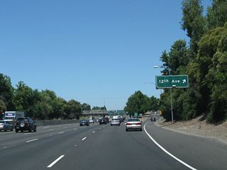 Northbound California 99 reaches Exit 297, 12th Avenue. The next exit is Exit 298A, Business Loop I-80 (Capital City Freeway) west, U.S. 50 west, Interstate 305 west, and California 99 north to downtown Sacramento, San Francisco, and Redding AND U.S. 50 (El Dorado Freeway) east to Placerville and South Lake Tahoe.