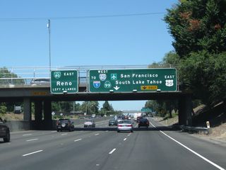The next exit along California 99 north is Exit 298A, Business Loop I-80 (Capital City Freeway) west, U.S. 50 west, Interstate 305 west, and California 99 north to downtown Sacramento, San Francisco, and Redding AND U.S. 50 (El Dorado Freeway) east to Placerville and South Lake Tahoe. Interstate 305 is a hidden route designation that follows the east-west portion of Business 80 and U.S. 50 between this interchange and Interstate 80 in West Sacramento. Note that California 99 will exit from itself and follow Business 80 west for a few miles, then transition onto Interstate 5 north. Ahead, the main lanes of California 99 will shift onto Business 80 east and California 51 north.
