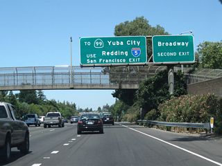 Take Business 80 west (via Exit 298A) to California 99 north. In addition, there is an exit for Broadway hidden in the middle of the upcoming interchange (Exit 298B).