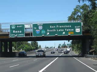 The right two lanes of California 99 will connect to Business Loop I-80, U.S. 50, Interstate 305 west and California 99 north and also to U.S. 50 east to Placerville. Meanwhile, the left four lanes continue straight ahead onto eastbound Business Loop I-80 and northbound California 51.  Don't look for too many California 51 signs; it is generally not posted but has its route number on the call boxes and postmiles. California 51 is defined to extend from this interchange northeast to the 80-80 Split (at the junction with California 244).
