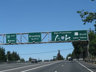 Northbound California 99 reaches Exit 298A, with the left four lanes connecting to Business Loop I-80 east and the right two lanes following California 99 north to Business Loop I-80 west. Use the left four lanes for Exit 298B (Broadway) and Exit 298C (Business Loop I-80 east and California 51 north).