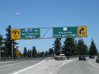 The transition ramp splits, with the left two lanes taking California 99 north onto Business 80 and U.S. 50 west to Interstate 5 north, and the right lane departing California 99 for U.S. 50 east to South Lake Tahoe.