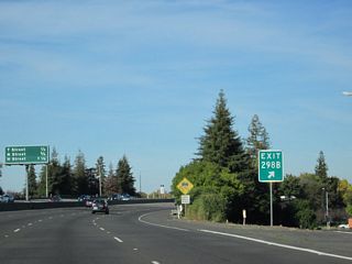 The exit number for CR J-8 (Broadway) is posted at the gore point.