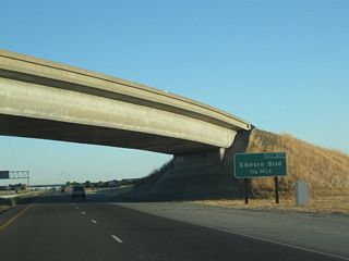 Back on its own alignment, the first exit along California 99 north after the split from Interstate 5 is Exit 307, Sacramento County Route E-14 (Elkhorn Boulevard). After Exit 307, California 99 becomes an expressway, with at-grade intersections, until Exit 319, which is the California 70 split.