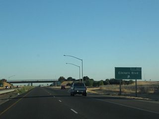 Northbound California 99 (El Centro Boulevard) meets Exit 307, Sacramento County Route E-14 (Elkhorn Boulevard) east to Rio Linda and North Highlands.