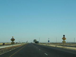 A traffic signal governs the intersection of California 99 (El Centro Boulevard) and Elverta Road.
