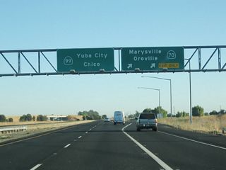 Northbound California 99 meets Exit 319, northbound California 70. California 70 roughly parallels California 99 to the east of the Feather River, while California 99 remains west of the Feather River. The Feather River is a major tributary of the Sacramento River. California 70 follows the north branch of the Feather River into the Sierra Nevada, following former U.S. 40 Alternate through the Feather River Canyon and ultimately to a junction with U.S. 395 just northwest of Reno, Nevada.