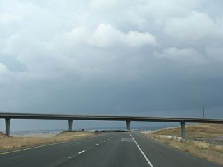 Northbound California 99 as it passes through the California 149 interchange. The southbound lanes first pass under the transition ramp from California 149 north to California 99 south, then pass over the California 149 mainline.