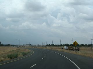 The two northbound lanes of California 99 will merge into one northbound lane as we approach the merge point with California 149 north.