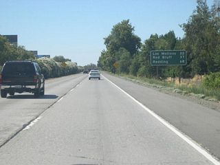 This mileage sign is posted after the on-ramp from Eaton Road; it provides the distance to Los Molinos (22 miles), Red Bluff (37 miles), and Redding (68 miles).