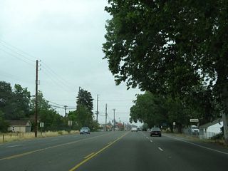 Through Gridley, California 99 widens to five lanes. The main intersection in downtown Gridley is with Sycamore Street, which travels west to become Colusa Highway en route to Colusa. Southwest of here are the Sutter Buttes, which are situated between California 99 and the Sacramento River.