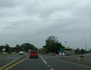 After the intersection with Live Oak Boulevard (old U.S. 99E), California 99 continues north as a two-lane highway. The next signed intersection is with Kent Avenue, which travels north while California 99 aims northwest.
