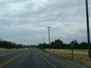 A California 99 north reassurance shield is posted after the Wilson Landing Road intersection.