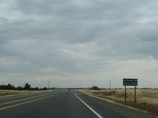 Northbound California 99 approaches the intersection with Rowles Road and Lassen Road.