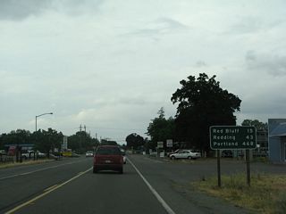 After the CR A-8 intersection, this mileage sign along northbound California 99 provides the distance to Red Bluff (15 miles), Redding (43 miles), and Portland (468 miles).