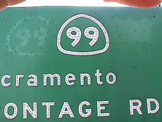 This sign clearly shows its age, as a U.S. 50 shield was scraped off of it. The California 99 was centered to cover the old shield partially.