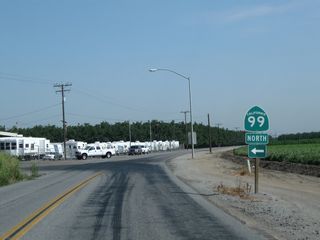 Another California 99 trailblazer sign is posted on northbound Road 100 (which serves as a frontage road north of Exit 90) in Tulare prior to the on-ramp to California 99 north.