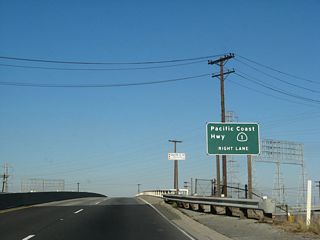 SR 103 (Terminal Island Freeway) converges with SR 1 (Pacific Coast Highway) at a cloverleaf interchange in a half mile.