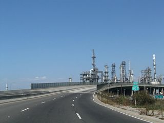 Elevating across SR 47, Pier A Avenue and Union Pacific Railroad tracks, SR 103 advances east through a chemical refinery complex.