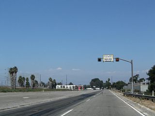 One third of a mile south of the signalized end of the Terminal Island Freeway at Willow Street.