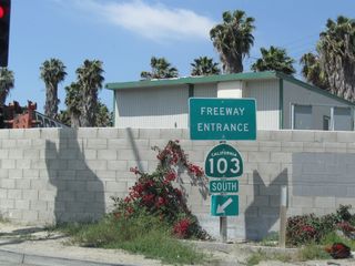 An initial freeway entrance shield assembly for SR 103 appears at the southwest corner of the intersection joining Willow Street and Terminal Island Freeway.