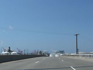 The entrance ramp from Southern Pacific Drive adds a third southbound lane along the Anaheim Street Overcrossing. However, changes made by 2015 included a lane drop beyond the elevated roadway.
