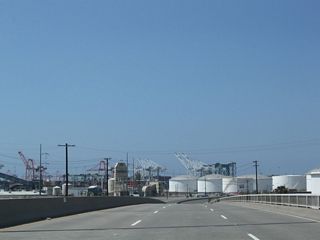 The viaduct taking SR 103 across Southern Pacific Drive, Anaheim Way, Anaheim Street and a railroad yard was built in 1947. The Terminal Island Freeway turns west from the bridge through an oil refinery complex.