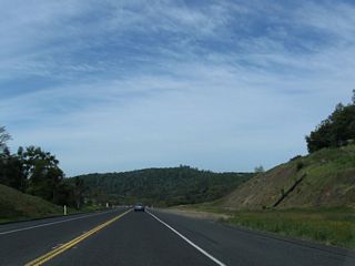 This roadway cut was initially built for the two-lane highway, but it has ample room to expand the bypass route to full freeway standards.