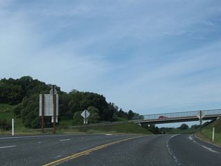 Westbound California 108 (Sonora Bypass) begins a rather steep descent along the 1987 Sonora Bypass. In the other direction is a guide sign for Mono Way, which includes a shield assembly for Business Route 108.