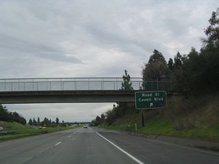 Northbound California 113 reaches Exit 29, Yolo County E-6 (Covell Boulevard) east to Davis and west to Winters.