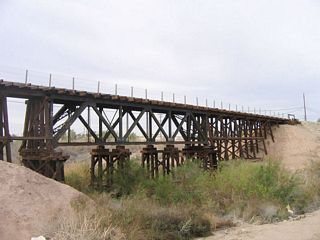 The Interurban Railway, which used to connect Holtville with El Centro, has many relics left along its route even though the railroad is not in use today. This picture shows the bridge (looking south and east) that the railroad uses to cross the Alamo River adjacent to California 115 (Old U.S. 80) in western Holtville.