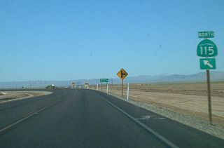 Northbound California 115 meets Eddins Road, Wirt Road, and West Road at this intersection. California 115 turns from a northerly to a westerly direction at this intersection.