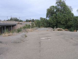 A remnant of old U.S. 80 is found on the south side of the Alamo River bridge. This twin-slab concrete section, which was covered in asphalt, used to bend to a different bridge over the river. That older bridge is gone, having been replaced by the current California 115 Alamo River Bridge.