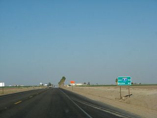 This mileage sign along California 78 east and California 115 south provides the distance to Interstate 8 (22 miles south via California 115) and Blythe (Interstate 10) (82 miles via California 78 east).