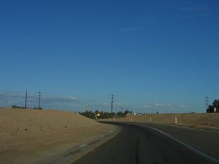 The continuation of California 115 south (east) is almost like a ramp leaving a highway as it goes around the median that likely was to be the foundation of a bypass route that would have taken U.S. 80 around Holtville to the south of the city. Such a bypass was never built and was no longer needed once Interstate 8 was built south of here.