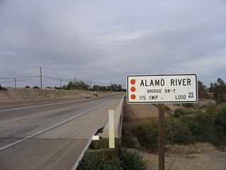 Like its companion the New River, the Alamo River flows northward from Mexico into the Salton Sea. The Alamo River also carries a significant share of pollutants as it travels north, mostly due to agricultural and urban runoff that constitutes the majority of its year-round flow. Such a year-round flow would otherwise not occur in the desert absent some other perpetual source of water. This bridge carries California 115 and U.S. 80 east over the Alamo River.