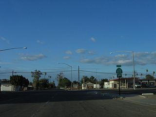 California 115 makes a right turn from Palm Avenue onto Fifth Street, the main east-west street through downtown Holtville.